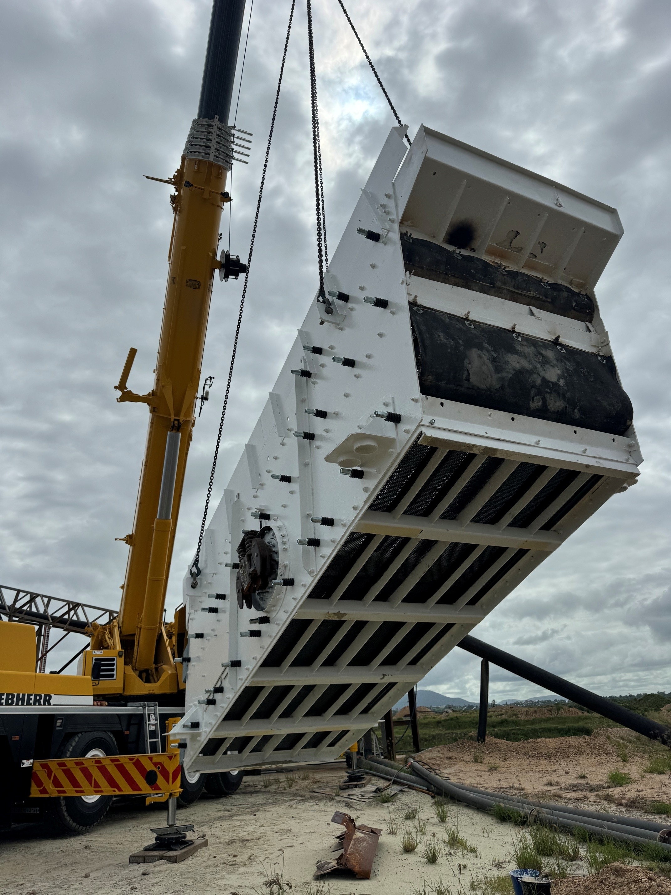 Large vibrating screen box rebuild being lifted by crane